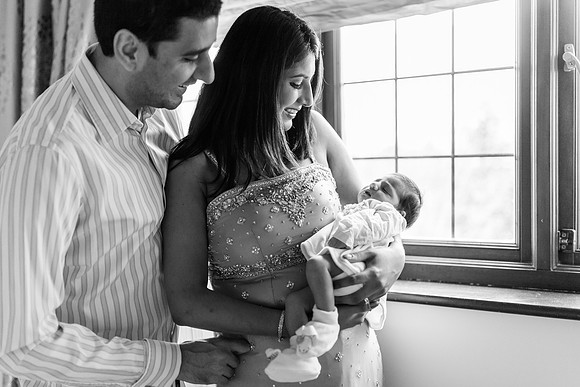 A proud mother and father with their new baby at home