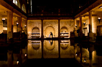 A Bride and Groom are silhouetted in the Roman Baths after their wedding ceremony
