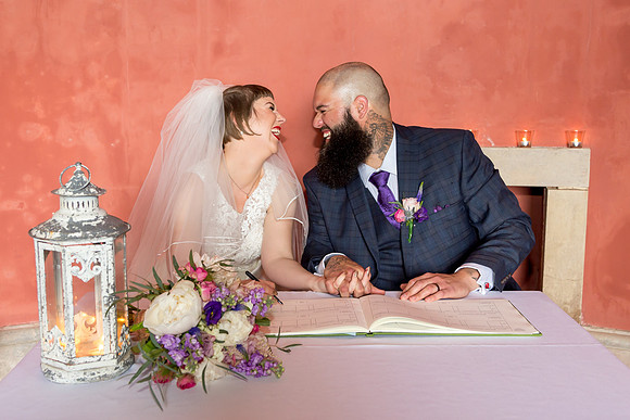 A Bride and Groom share a giggle after their wedding at Stourhead