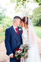 A Bride and Groom share an intimate moment after their wedding at the Great Tythe Barn in Tetbury