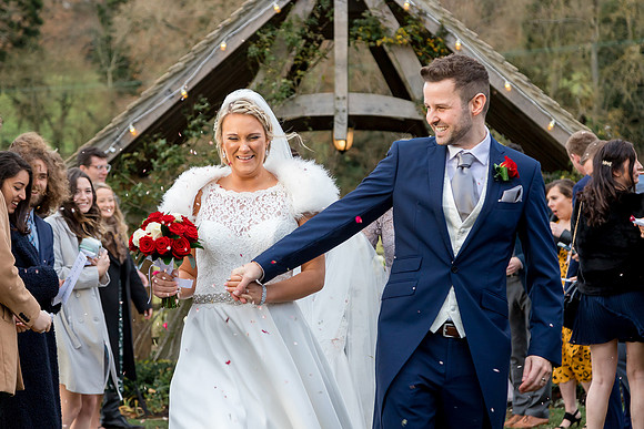 Bride and Groom showered in confetti after their wedding at Hyde House in the Cotswolds