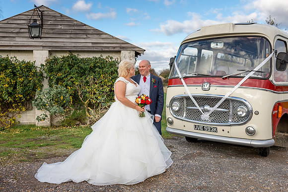 A Bride and Groom with a vintage bus at their wedding at Moonrakers Hotel in Trowbridge