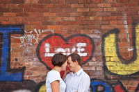 Pre-weddding photoshoot in front of graffiti wall saying love