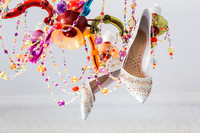 Bridal shoes hanging in chandelier